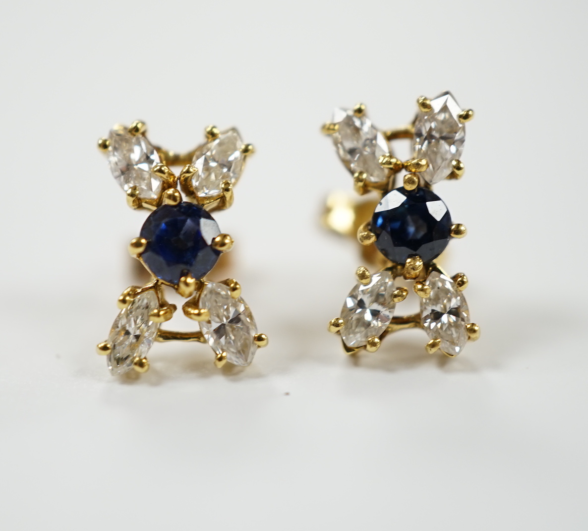 A modern pair of 18ct gold, sapphire and diamond cluster set 'X' ear studs, 12mm, gross weight 2.2 grams.